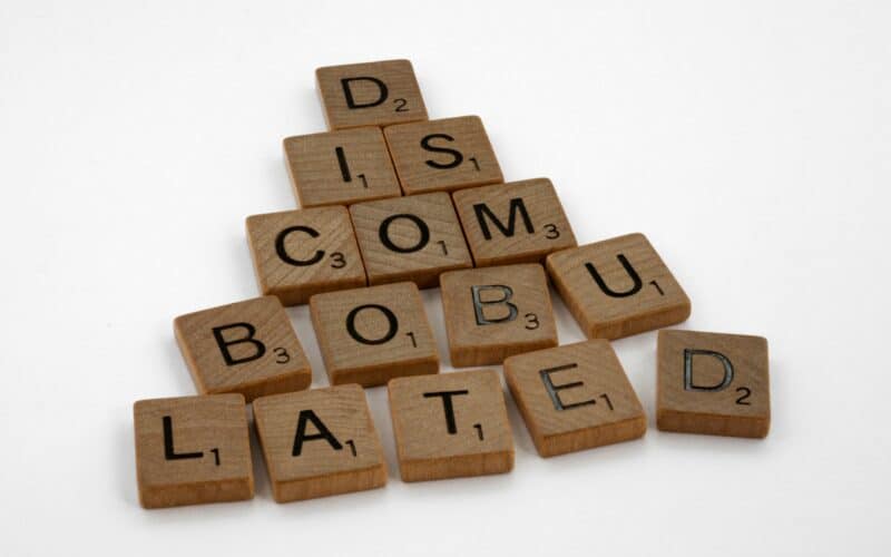 Scrabble tiles spelling out "Discombobulated"